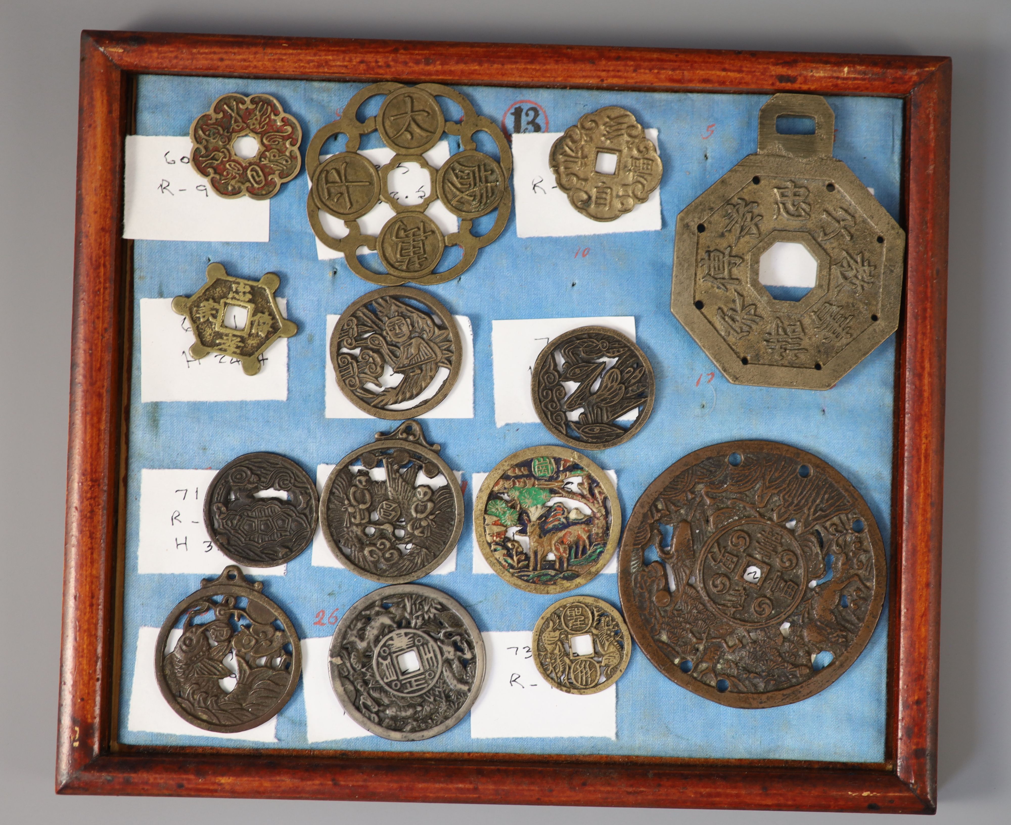 A group of 99 Korean bronze and metal amulets or charms, 19th/20th century